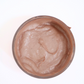 Close-up view of French pink clay face mask texture