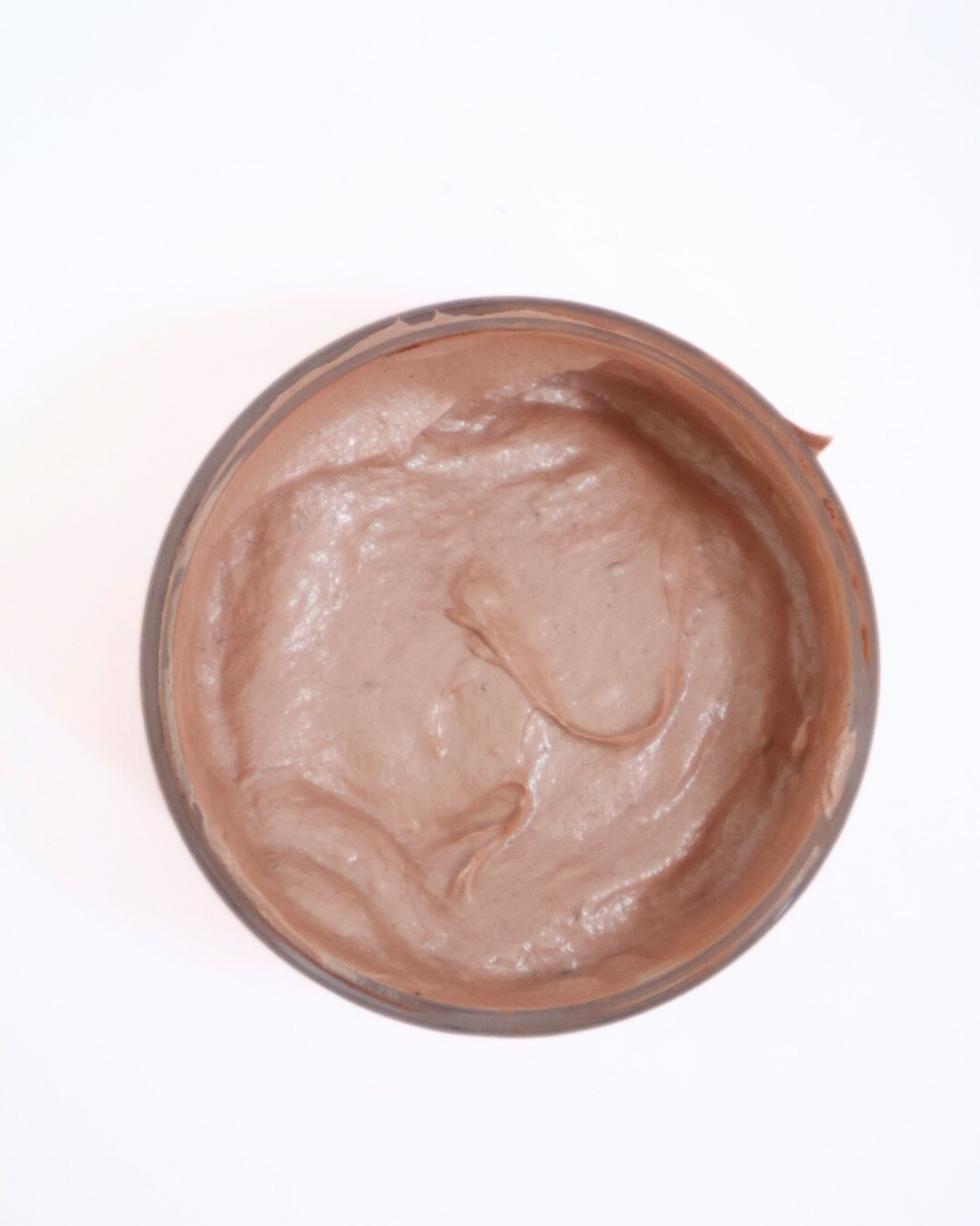 Close-up view of French pink clay face mask texture